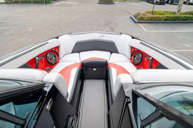 Slide: The Image of 2019 MasterCraft X-Star boat interior with red and white seating and speakers. - 20