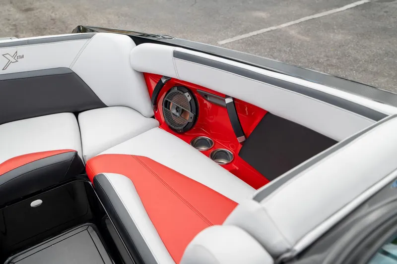 Slide: The Image of 2019 MasterCraft X-Star interior with red, white, and black seating, featuring cup holders and speaker. - 21