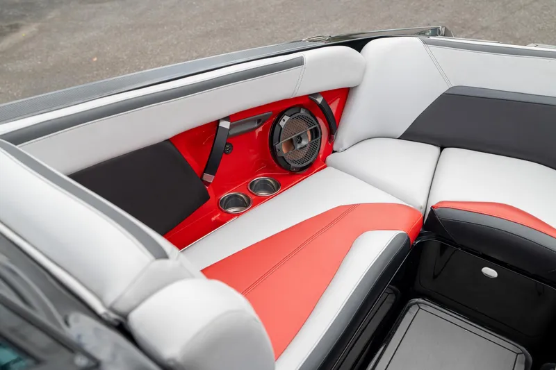 Slide: The Image of 2019 MasterCraft X-Star interior with red and white seating, speaker, and cup holders. - 22