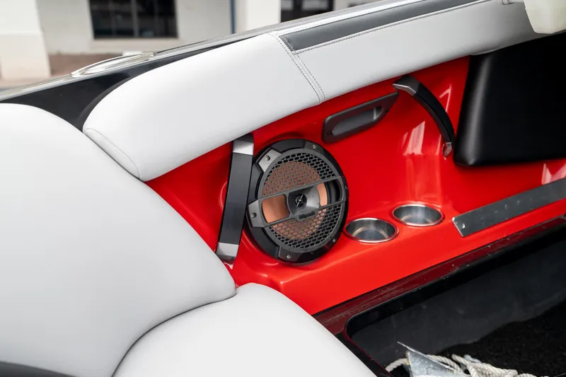 Slide: The Image of 2019 MasterCraft X-Star interior with speaker and cup holders, featuring red and white design. - 23