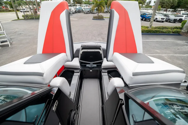 Slide: The Image of 2019 MasterCraft X-Star boat interior with red and white seating and storage compartments. - 25