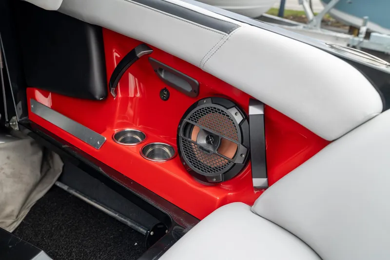 Slide: The Image of 2019 MasterCraft X-Star interior with red panel, speaker, and cup holders. - 27