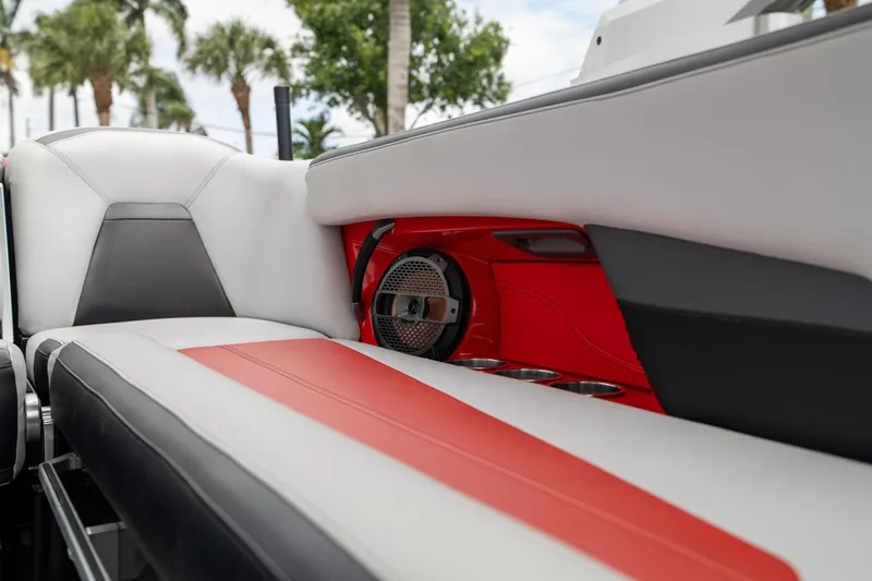Slide: The Image of 2019 MasterCraft X-Star interior with red and gray seating, speaker, and cup holders. - 32