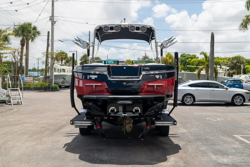 Slide: The Image of 2019 MasterCraft X-Star boat on trailer, parked outdoors under a cloudy sky. - 7