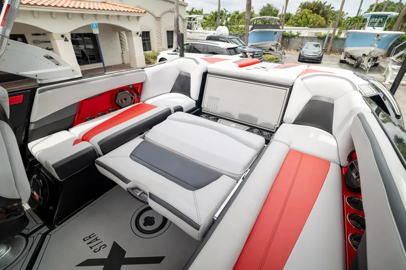 Slide: The Image of 2019 MasterCraft X-Star boat interior with red and white seating, showcasing luxury design. - 9