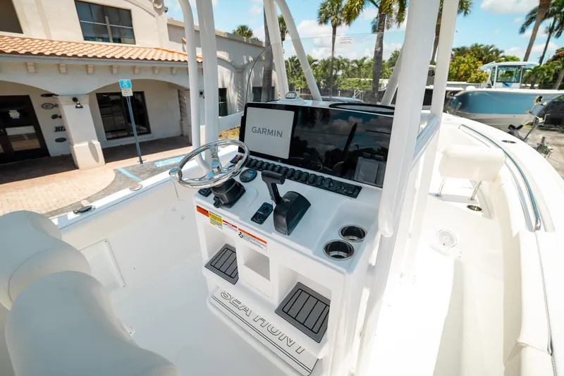 Slide: The Image of 2025 Sea Hunt Ultra 219 boat console with Garmin navigation system and steering wheel. - 10