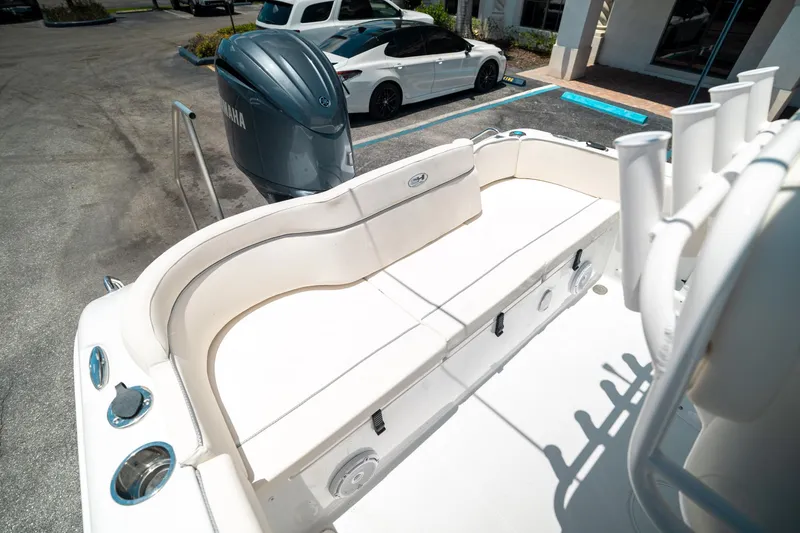 Slide: The Image of 2025 Sea Hunt Ultra 219 boat with Yamaha engine, parked in a lot. - 21