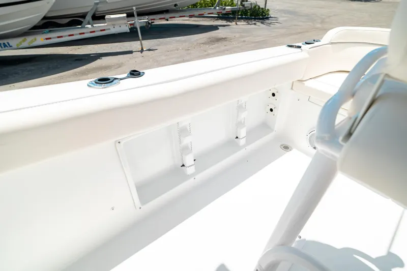 Slide: The Image of 2025 Sea Hunt Ultra 219 boat interior, featuring sleek white seating and storage compartments. - 27