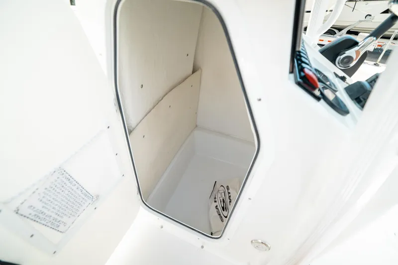 Slide: The Image of 2025 Sea Hunt Ultra 219 boat storage compartment interior view. - 28