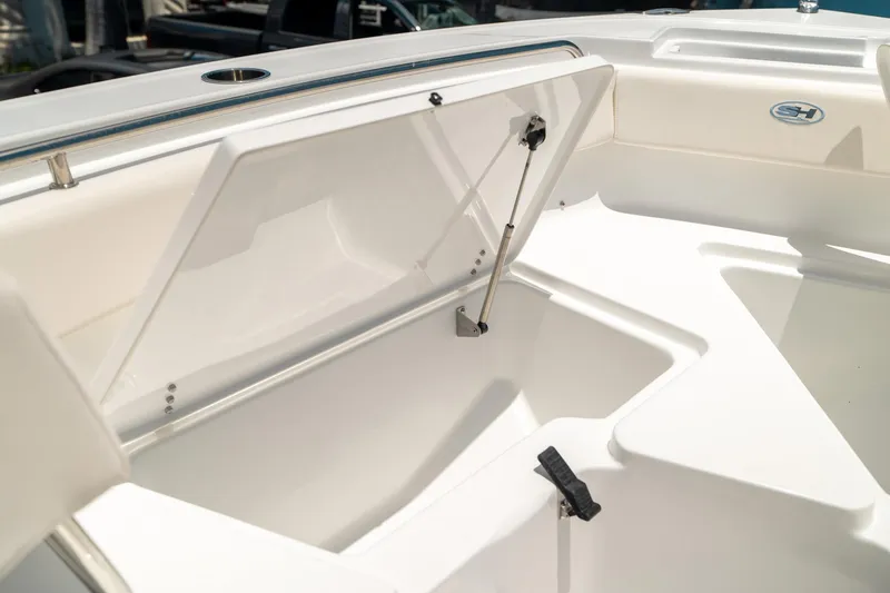 Slide: The Image of 2025 Sea Hunt Ultra 219 boat storage compartment open, showcasing interior space. - 36
