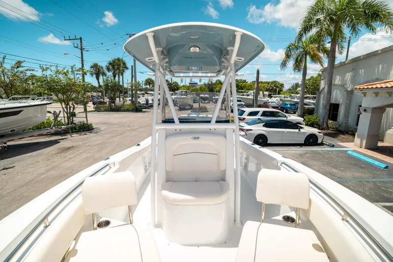 Slide: The Image of 2025 Sea Hunt Ultra 219 boat in a sunny marina setting. - 39