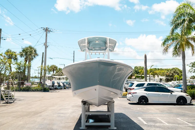 Slide: The Image of 2025 Sea Hunt Ultra 219 boat displayed in a sunny parking lot. - 7
