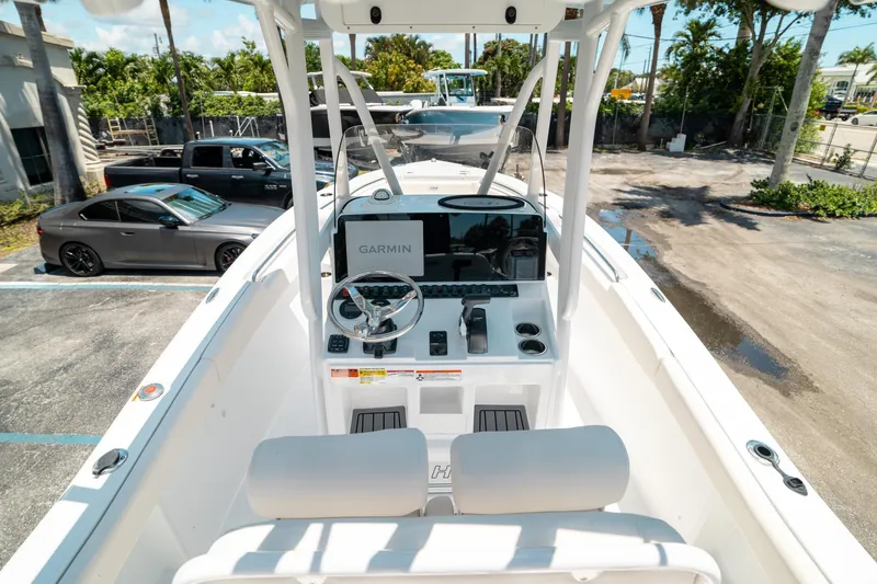 Slide: The Image of 2025 Sea Hunt Ultra 219 boat dashboard with Garmin navigation system in a parking lot. - 9