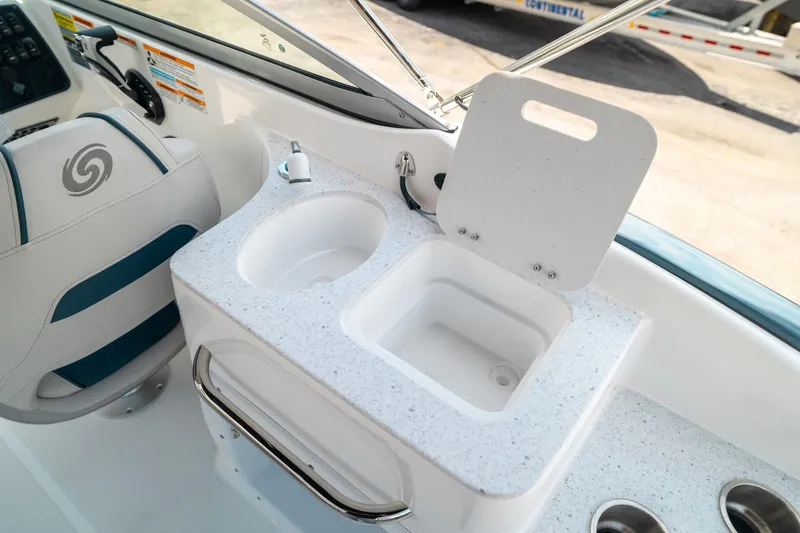 Slide: The Image of 2024 Hurricane SunDeck 2400 OB boat interior with sink and seating area. - 16