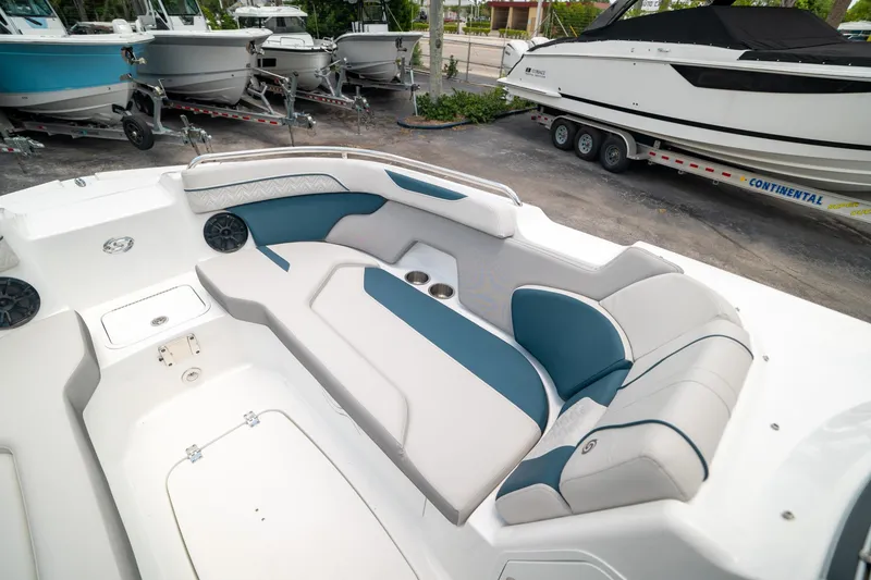 Slide: The Image of 2024 Hurricane SunDeck 2400 OB boat interior with cushioned seating and cup holders. - 29