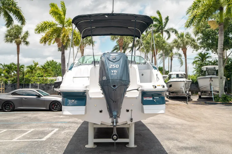 Slide: The Image of 2024 Hurricane SunDeck 2400 OB boat with Yamaha 250 V6 engine, parked outdoors. - 3