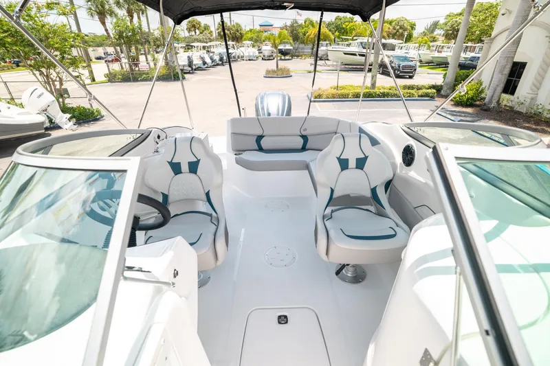 Slide: The Image of 2024 Hurricane SunDeck 2400 OB interior with modern seating and steering wheel. - 11