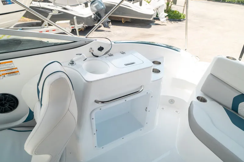 Slide: The Image of 2024 Hurricane SunDeck 2400 OB boat interior with seating and sink area. - 15