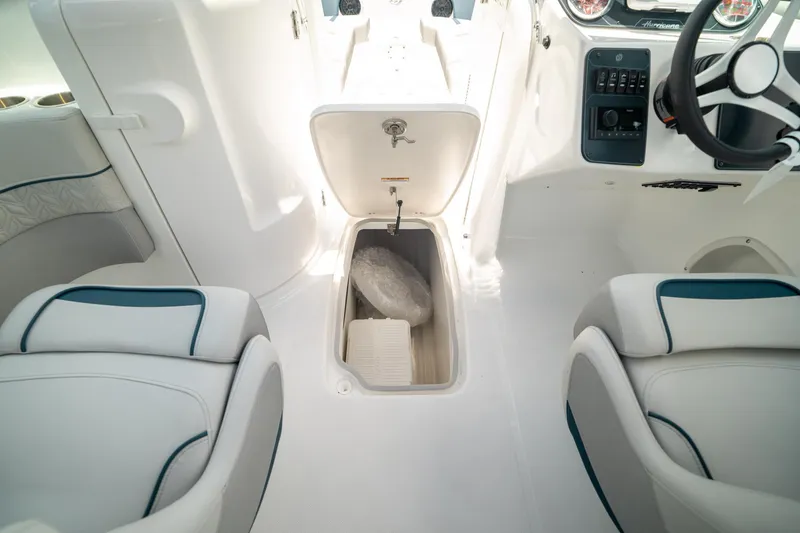 Slide: The Image of 2024 Hurricane SunDeck 2400 OB boat interior with storage compartment and seating. - 26