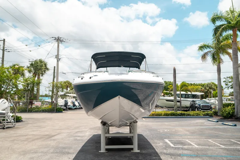 Slide: The Image of 2024 Hurricane SunDeck 2400 OB boat displayed outdoors on a sunny day. - 7