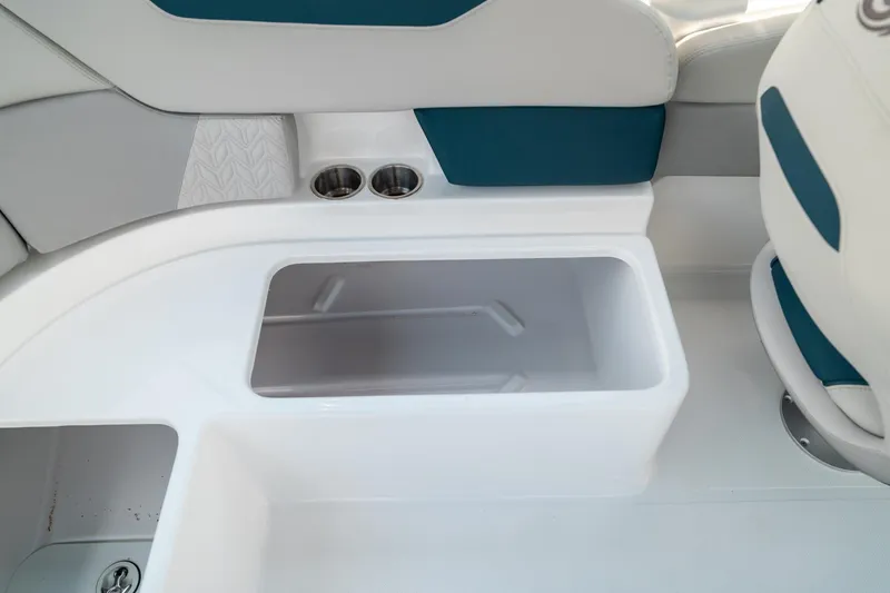 Slide: The Image of 2024 Hurricane SunDeck 2400 OB boat interior with storage compartment and cup holders. - 14
