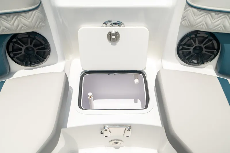 Slide: The Image of 2024 Hurricane SunDeck 2400 OB boat interior with open storage compartment and speakers. - 33