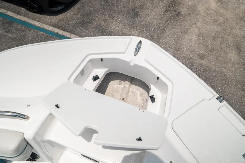Slide: The Image of 2024 Hurricane SunDeck 2400 OB boat deck with storage compartment open. - 34