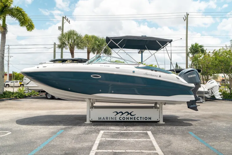 Slide: The Image of 2024 Hurricane SunDeck 2400 OB boat displayed at Marine Connection dealership. - 5