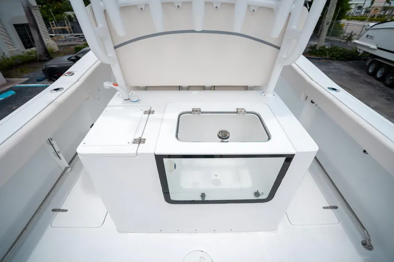 Slide: The Image of 2025 Sea Hunt Gamefish 28 FS boat deck with livewell and storage compartments. - 17