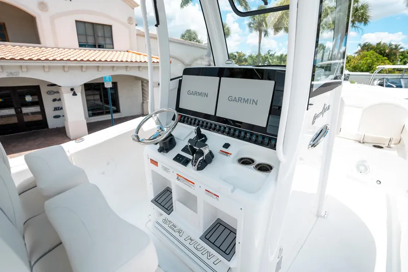 Slide: The Image of 2025 Sea Hunt Gamefish 28 FS boat console with Garmin displays and steering wheel. - 25