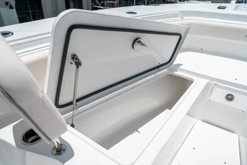 Slide: The Image of 2025 Sea Hunt Gamefish 28 FS boat storage compartment open, showcasing interior space. - 45