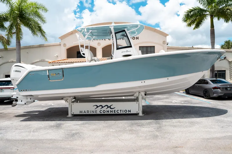 Slide: The Image of 2025 Sea Hunt Gamefish 28 FS boat displayed at Marine Connection dealership. - 1
