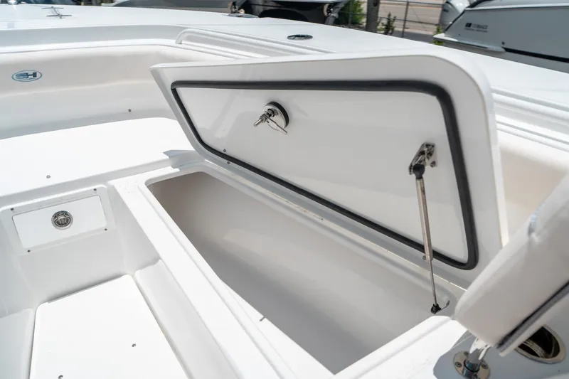 Slide: The Image of 2025 Sea Hunt Gamefish 28 FS boat storage compartment open, showcasing interior space. - 46