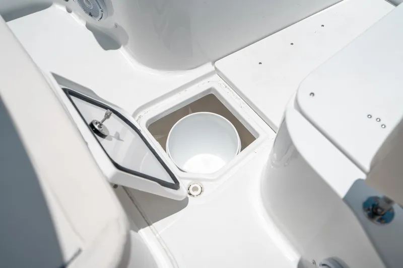 Slide: The Image of 2025 Sea Hunt Gamefish 28 FS boat storage compartment with open hatch and bucket. - 47