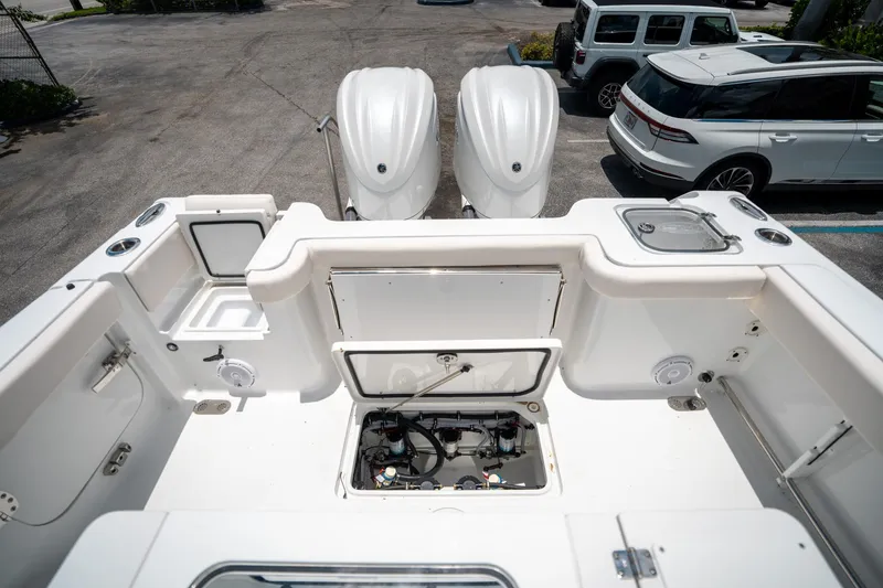 Slide: The Image of 2025 Sea Hunt Gamefish 28 FS boat deck with dual engines and storage compartments. - 15