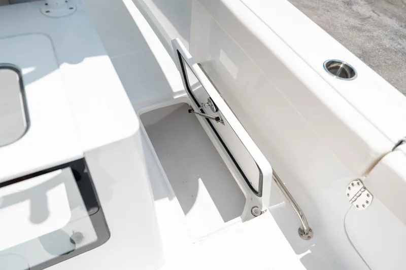 Slide: The Image of 2025 Sea Hunt Gamefish 28 FS boat storage compartment, open hatch, white interior. - 21
