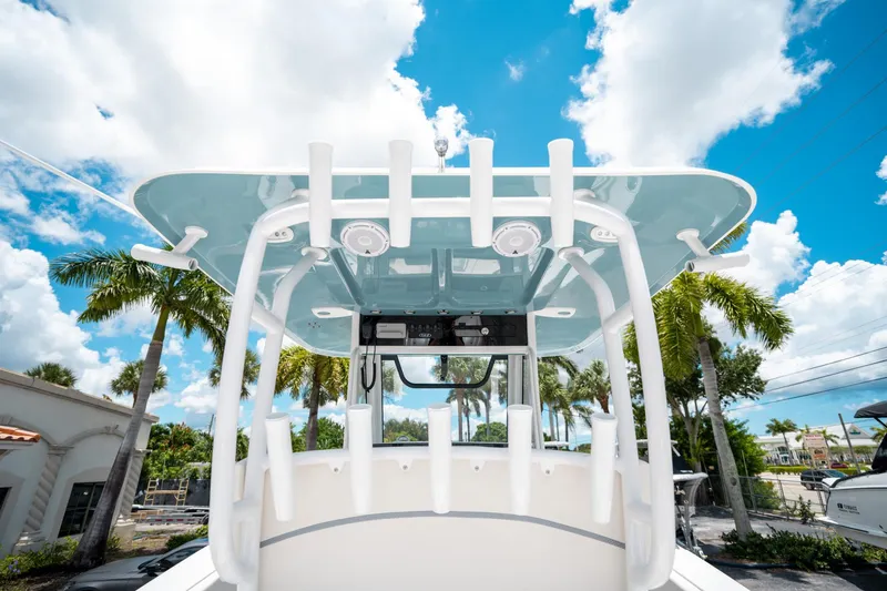 Slide: The Image of 2025 Sea Hunt Gamefish 28 FS boat with T-top, under a bright blue sky. - 27