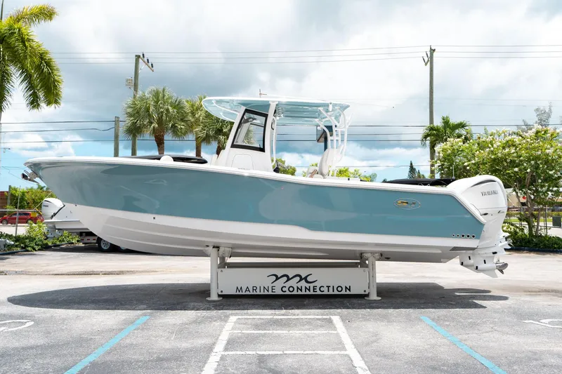 Slide: The Image of 2025 Sea Hunt Gamefish 28 FS boat displayed outdoors on a stand. - 5