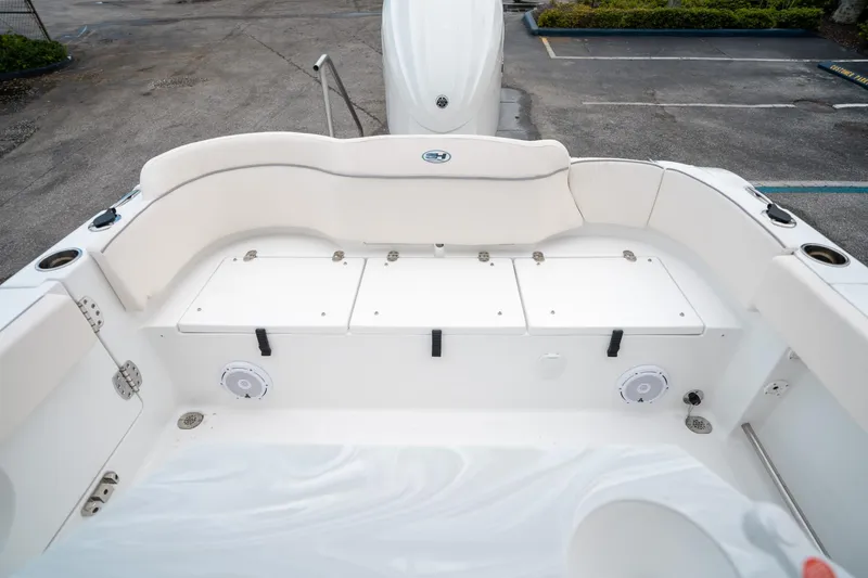 Slide: The Image of 2025 Sea Hunt Ultra 239 SE boat interior with white seating and storage compartments. - 16