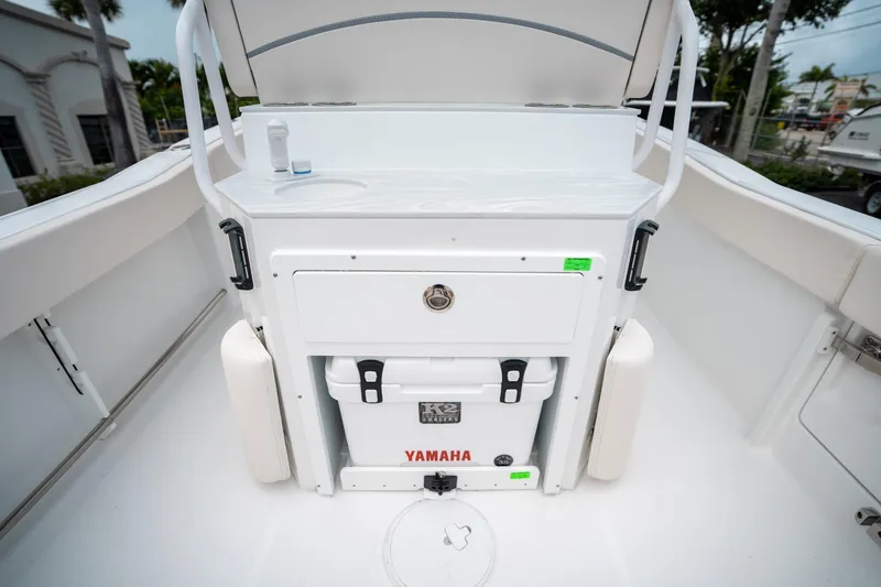 Slide: The Image of 2025 Sea Hunt Ultra 239 SE boat interior with Yamaha cooler and storage compartment. - 18
