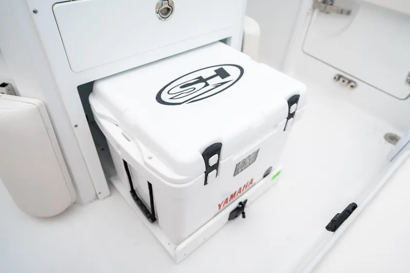 Slide: The Image of 2025 Sea Hunt Ultra 239 SE boat with Yamaha cooler in storage compartment. - 22