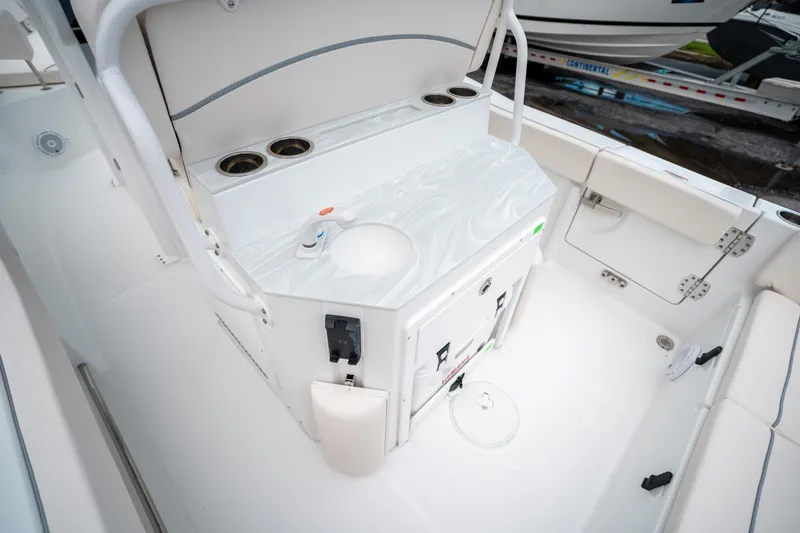 Slide: The Image of Interior view of 2025 Sea Hunt Ultra 239 SE boat, featuring a sleek white design. - 23