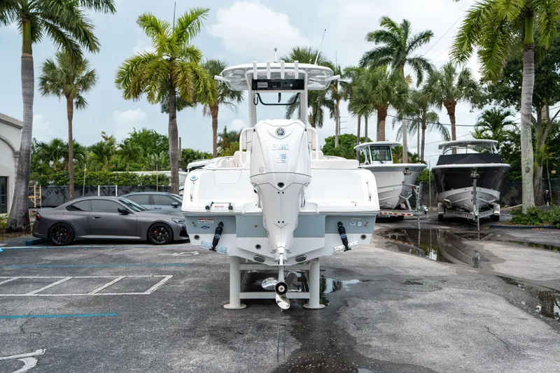 Slide: The Image of 2025 Sea Hunt Ultra 239 SE boat in a parking lot with palm trees. - 3