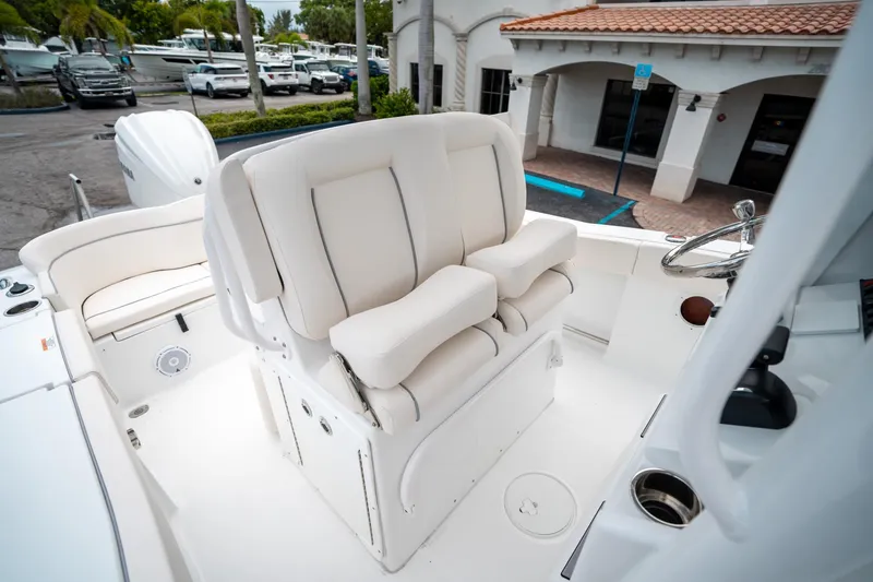 Slide: The Image of 2025 Sea Hunt Ultra 239 SE boat with plush white seating and steering wheel. - 31