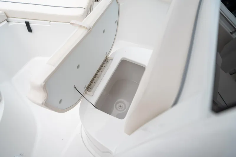 Slide: The Image of 2025 Sea Hunt Ultra 239 SE boat storage compartment with open lid. - 42
