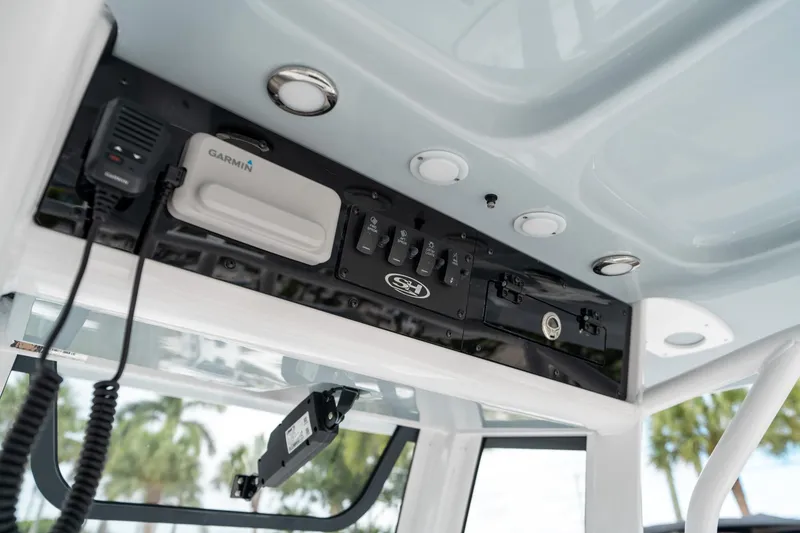 Slide: The Image of 2025 Sea Hunt Ultra 239 SE boat console with Garmin electronics and control panel. - 43