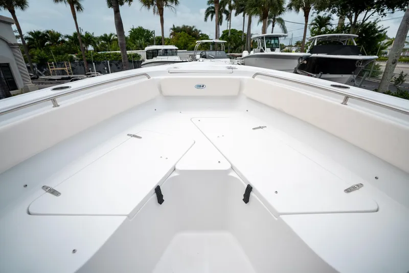 Slide: The Image of 2025 Sea Hunt Ultra 239 SE boat interior with spacious seating and storage. - 46