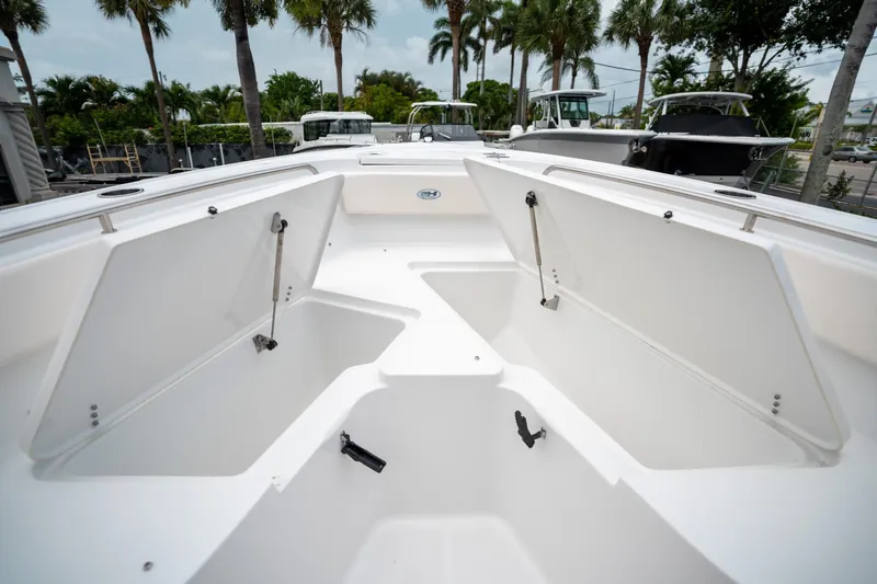 Slide: The Image of 2025 Sea Hunt Ultra 239 SE boat storage compartments open, showcasing spacious design. - 47