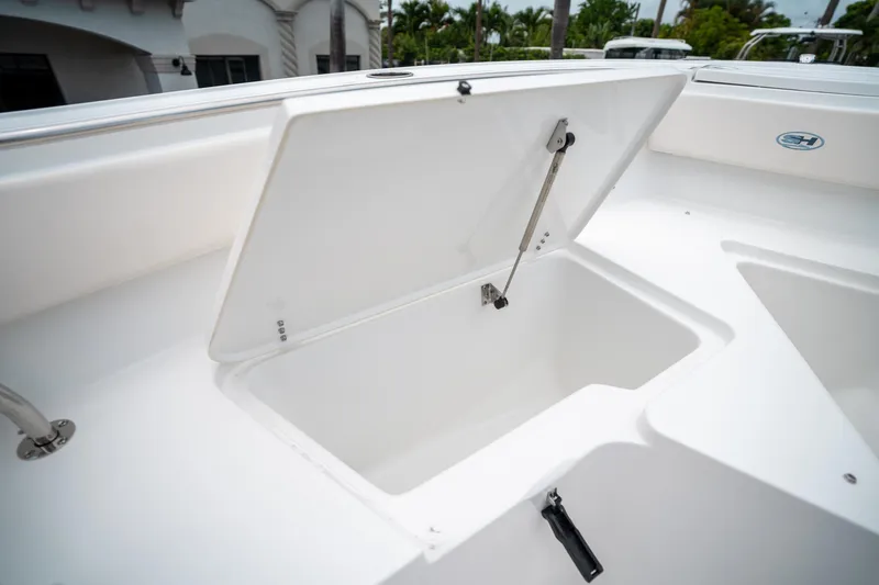 Slide: The Image of Open storage compartment on 2025 Sea Hunt Ultra 239 SE boat. - 48