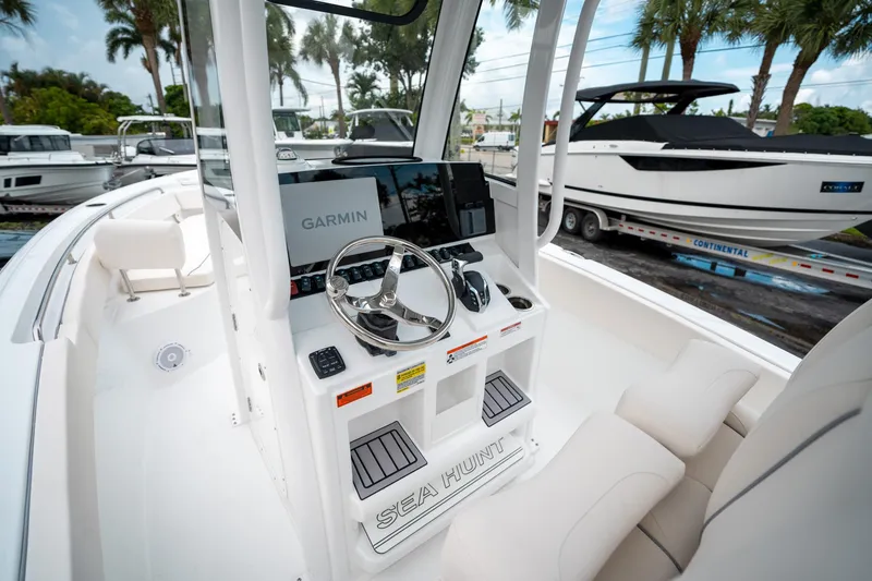 Slide: The Image of 2025 Sea Hunt Ultra 239 SE boat cockpit with Garmin navigation system. - 12
